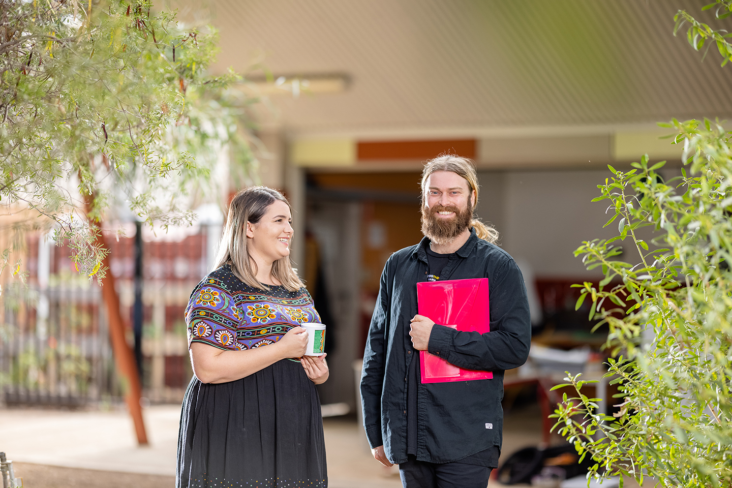 Male and female teacher standing together