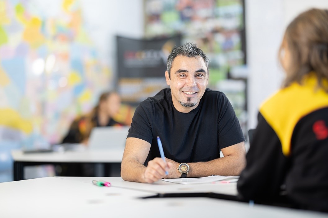 Male teacher with a group of secondary students