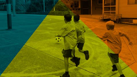 students are playing soccer in outdoor area