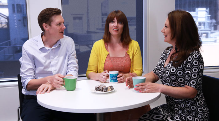 Staff in discussion at table in break room