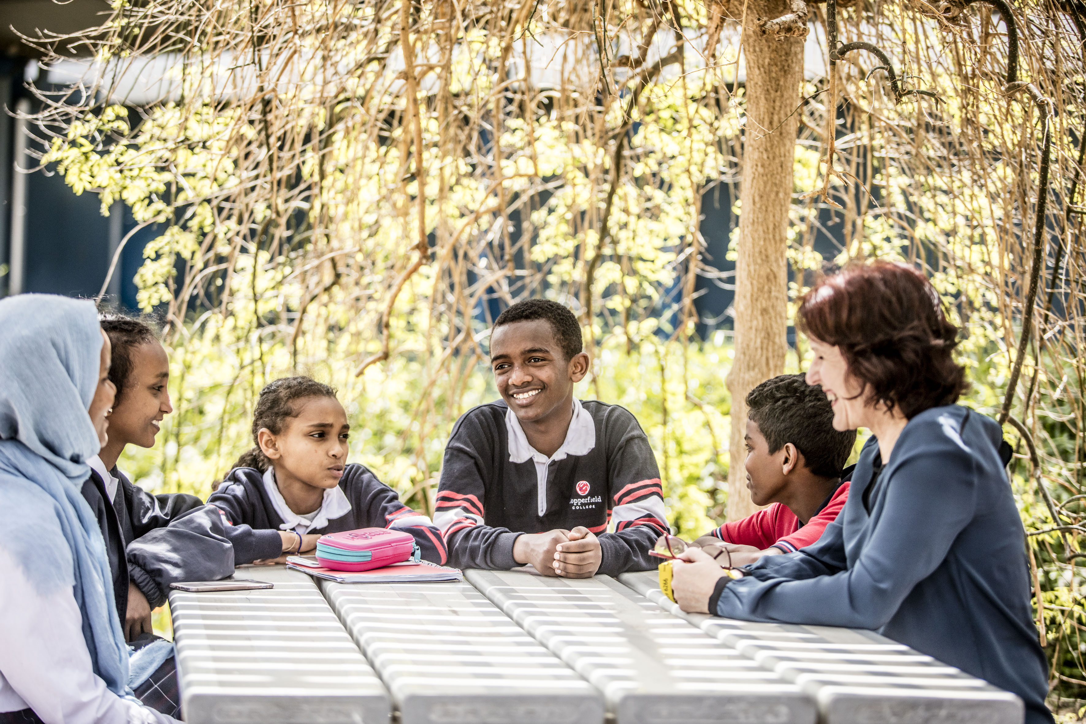 teacher and students outdoor chat