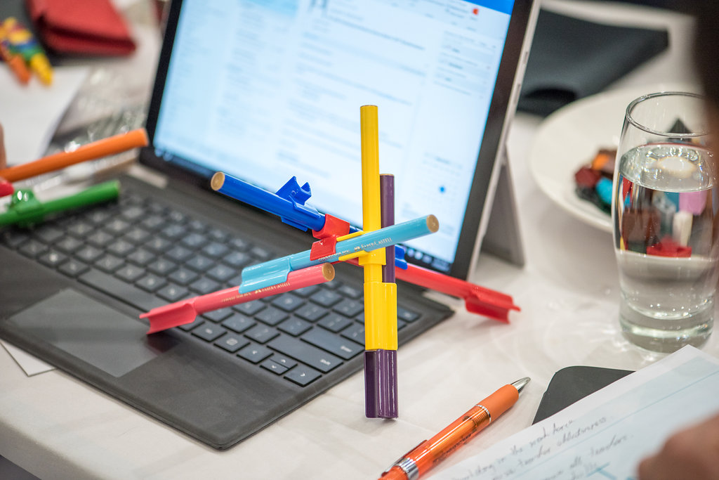 Stationery and laptop on desk.