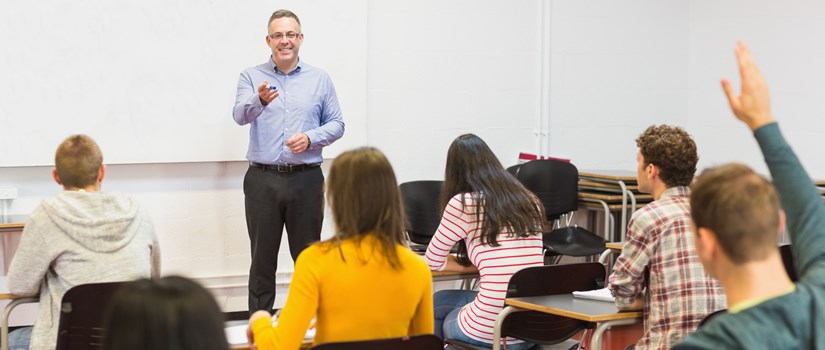 Student raising hand in class. Teacher making gesture of invitation.