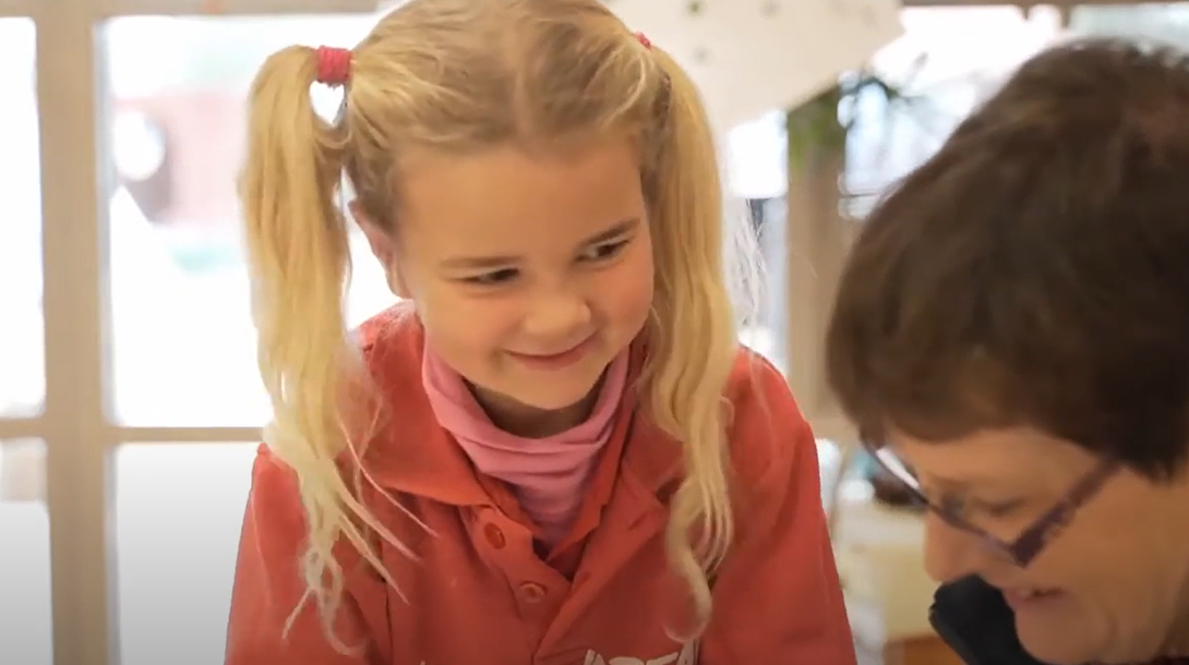 A close-up of learner alongside their teacher.
